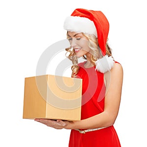 Smiling woman in santa helper hat with gift box