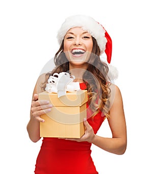 Smiling woman in santa helper hat with gift box