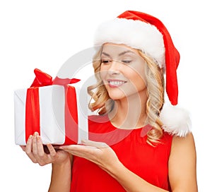 Smiling woman in santa helper hat with gift box