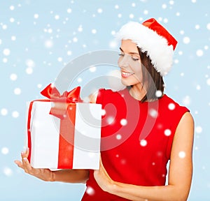 Smiling woman in santa helper hat with gift box