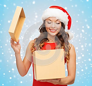 Smiling woman in santa helper hat with gift box