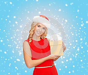 Smiling woman in santa helper hat with gift box