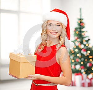 Smiling woman in santa helper hat with gift box