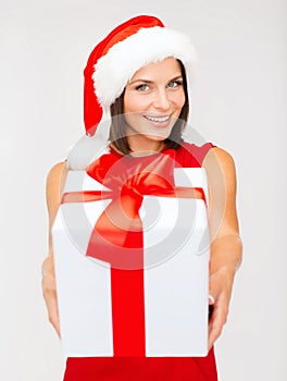 Smiling woman in santa helper hat with gift box