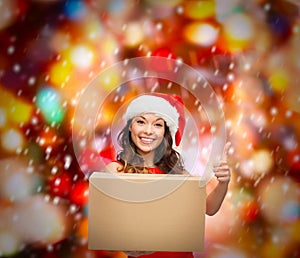 Smiling woman in santa helper hat with parcel box