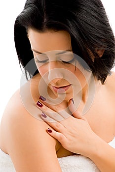 Smiling woman scrubbing her body photo