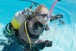 Smiling woman on scuba training in swimming pool