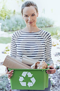 Smiling woman segregating paper junk