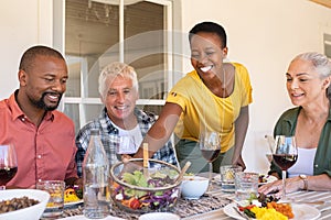 Smiling woman serving bowl of salad