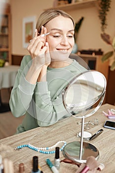 Smiling Woman Shaping Eyebrows at Home