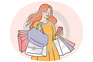 Smiling woman with shopping bags and cellphone