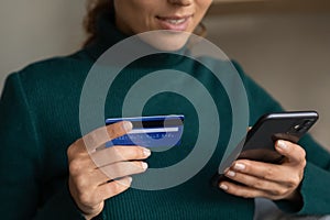 Smiling woman shopping online with credit card