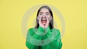 Smiling Woman Shouting In Hand Loudspeaker On Yellow Background
