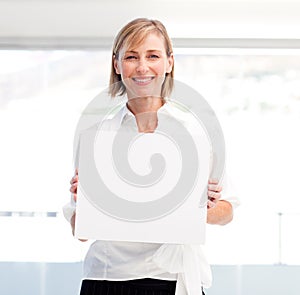 Smiling woman showing a big business card