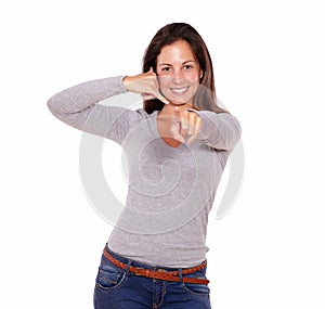 Smiling woman showing call me gesture with hand