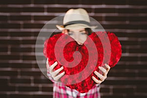 Smiling woman showing heart shape