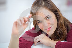 Smiling woman showing keys