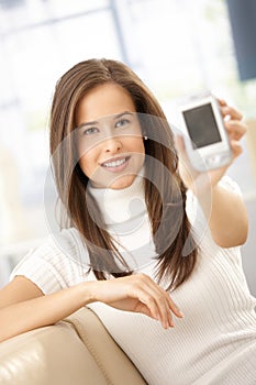 Smiling woman showing mobile phone