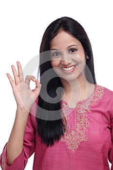 Smiling woman showing OK sign gesture