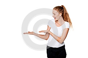 Smiling woman showing open hand palm with copy space