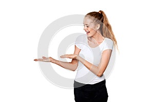 Smiling woman showing open hand palm with copy space