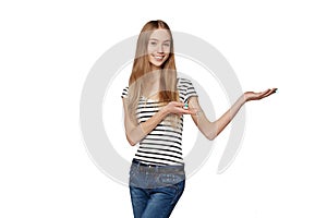 Smiling woman showing open hand palm with copy space for product