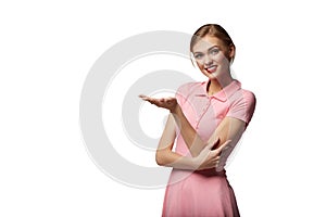 Smiling woman showing open hand palm with copy space for product