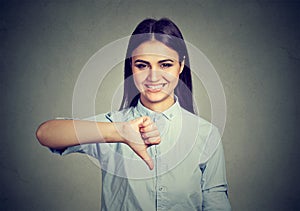 Smiling woman showing thumbs down