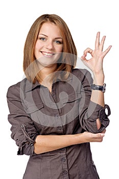 Smiling woman shows sign okay