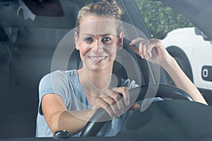 smiling woman sitting in car