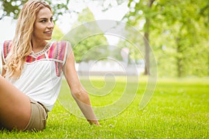 Smiling woman sitting on grass