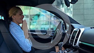 Smiling woman sitting in new car, satisfied with luxury service during purchase photo