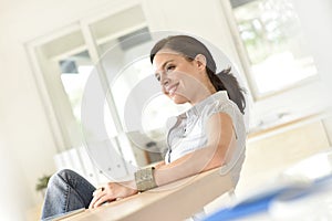 Smiling woman sitting in office