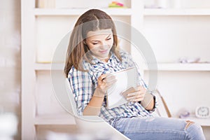 Smiling woman with smartphone and notepad