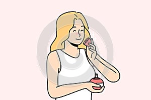 Smiling woman smelling perfume