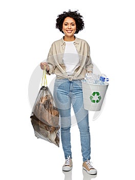 smiling woman sorting plastic and paper waste