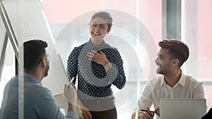 Smiling woman speaker laugh talking with colleagues at briefing