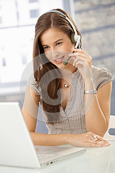 Smiling woman speaking on headset