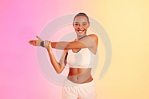 A smiling woman in sportswear checks her fitness tracker during a workout, showcasing a healthy lifestyle