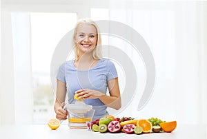 Smiling woman squeezing fruit juice at home