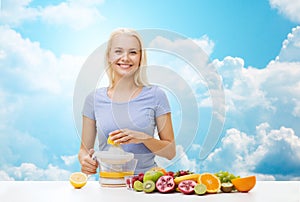 Smiling woman squeezing fruit juice over sky