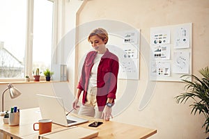 Smiling Woman Standing Office. Positive Businesswoman Looking Laptop Screen