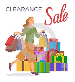 Smiling woman is standing with shopping bags. Big present boxes. Holliday sale and clearance concept