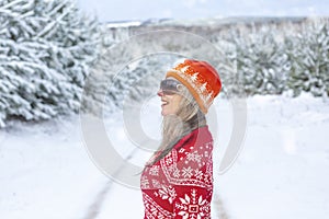 Smiling woman standing in a snow covered landscape