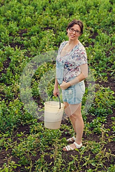 Smiling woman standing on an uncultivated agricultural field