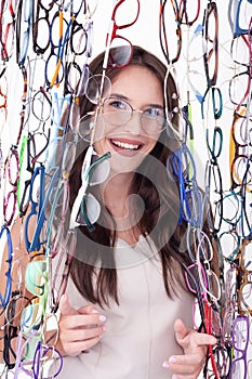 Smiling Woman Surrounded by Eyeglass Frames