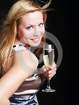 Smiling woman with sylvester champagne over dark photo