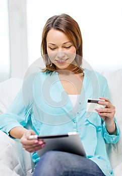 Smiling woman with tablet pc computer at home