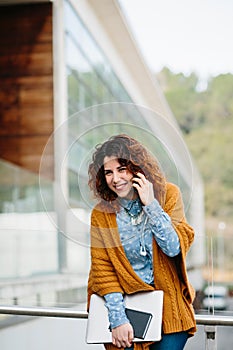 Smiling woman talking cell phone