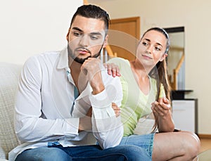 Smiling woman talking to upset man